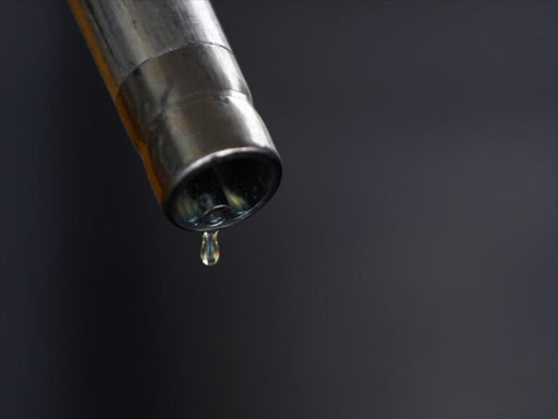 A drop of diesel is seen at the tip of a nozzle after a fuel station customer fills her car's tank in Sint Pieters Leeuw December 5, 2014. /REUTERS