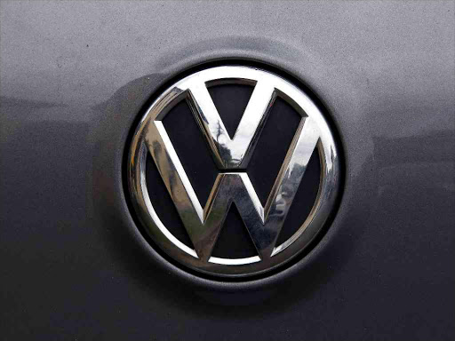 A Volkswagen logo is seen on one of the German automaker's cars in a street in Sydney, Australia, October 8, 2015. /REUTERS