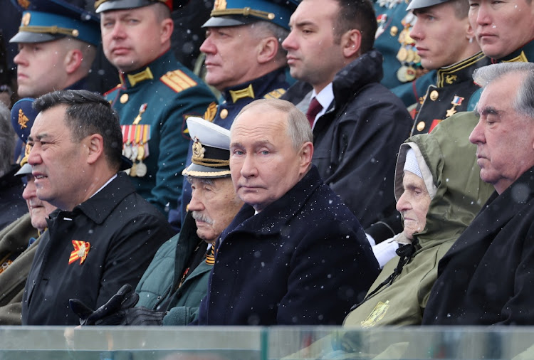 Spectators, including Russian President Vladimir Putin, watch a military parade on Victory Day, which marks the 79th anniversary of the victory over Nazi Germany in World War Two, in Red Square in Moscow, Russia, on May 9, 2024. Picture: SPUTNIK/MIKHAIL KLIMENTYEV/POOL via REUTERS