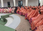 Nigerian students and staff who were kidnapped this month sit after they arrived at the local government house in Kaduna, Nigeria, on March 25 2024. 