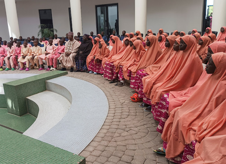 Nigerian students and staff who were kidnapped this month sit after they arrived at the local government house in Kaduna, Nigeria, on March 25 2024.