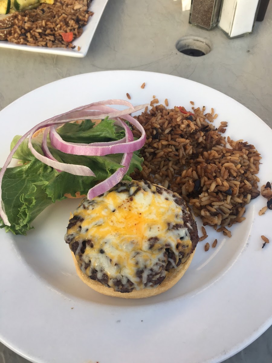 Cheese burger with cheddar jack cheese, lettuce, and onion, on a gf bun. Red pepper rice as the side.