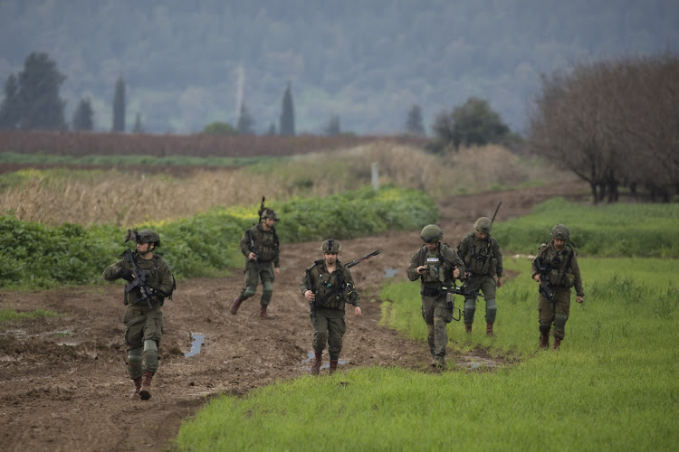 Israeli soldiers search a field after two drones allegedly crossed from Lebanese territory into Israel fell near the Kibbutz in Northern Israel on January 25 2024 in Kfar Blum, Israel. Picture: GETTY IMAGES/AMIR LEVY