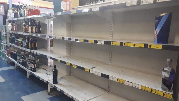 Shelves that were fully stocked this morning are close to empty at the Melville Liquor store in Johannesburg.