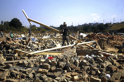 Alexandra residents pick up the pieces from the rubble after the Red Ants, backed by the Joburg Metro Police Department officers, demolished their illegally built homes. /Kabelo Mokoena