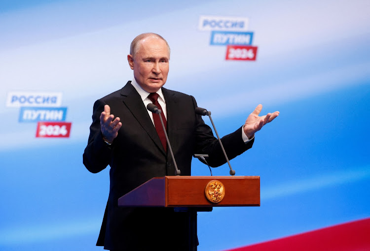 Russian presidential candidate and incumbent President Vladimir Putin speaks at his election campaign headquarters, after polling stations closed on the final day of the presidential election in Moscow. Picture: MAXIM SHEMETOV