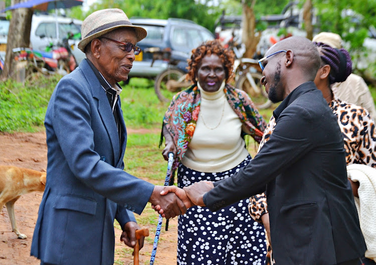Dr. Eliud Maluki , a school mate and agemates of the fallen former Kitui North MP , Justus Kitonga is welcomed to the latter's burial at Kyamboo village in Mwingi West sub county, Kitui by his nephew Micheal Kitonga.