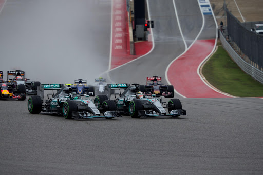 AUSTIN, TX - OCTOBER 25: Lewis Hamilton of Great Britain overtakes Nico Rosberg of Germany both of Mercedes at the start during the United States Formula One Grand Prix at Circuit of The Americas on October 25, 2015 in Austin, United States. (Photo by Peter J Fox/Getty Images)