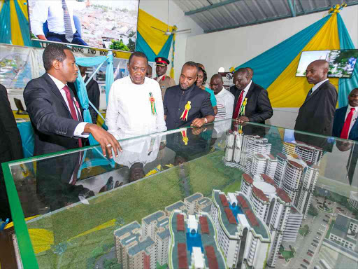 President Uhuru Kenyatta and Mombasa County Governor Hassan Joho are shown a modern city plan for Mombasa County by the Executive Member for Lands Anthony Njaramba(2nd Left), during a guided tour of the County's exhibition stands at the Mombasa International Show, Sep 1st 2016. PSCU