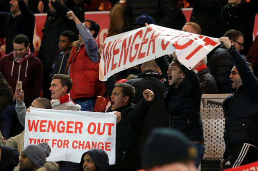 Arsenal fans hold "Wenger Out" banners in reference to Arsenal's French manager Arsene Wenger during the English Premier League football match between Middlesbrough and Arsenal at Riverside Stadium in Middlesbrough, northeast England on April 17, 2017. Arsenal won the match 2-1.