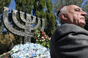 A Jewish man reacts during memorial ceremony at Minora Monument to pay tribute to victims of the Nazi massacre of Jews at Babi Yar ravine in Kiev.