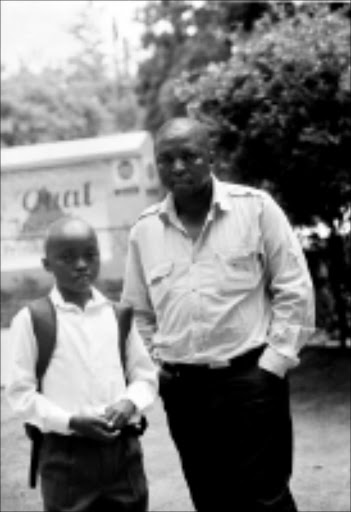 INJUSTICE: Khanyo Radebe and his father Tama leave Vaal Triangle Primary School in Vanderbijlpark after Khanyo was expelled. 14/01/2009. Pic. Len Kumalo. © Sowetan.