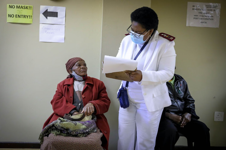 At the age of 103, Maria Lekiti gets vaccinated by Sister Ramatsobane Mahlangu at the Munsieville Care for the Aged home in Krugersdorp in phase two of the vaccine rollout targeted at the elderly.