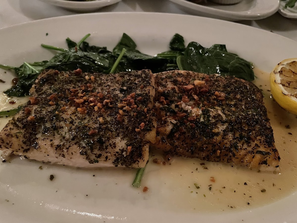 White fish with an herbal crust and garlic spinach