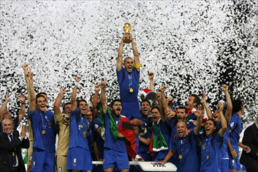 PICTURES OF THE YEAR 2006 Italy's Fabio Cannavaro (C) lifts the World Cup Trophy as he celebrates with team mates after the World Cup 2006 final soccer match between Italy and France in Berlin July 9, 2006. FIFA RESTRICTION - NO MOBILE USE REUTERS/Michael Dalder WORLD CHAMPS: Italy's Fabio Cannavaro hoists the World Cup trophy as he celebrates with teammates after his country won the World Cup 2006 final against France in Berlin, Germany, in July last year. page 20. sow. 29/20/07.