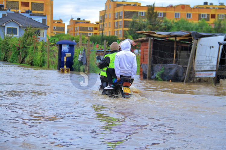 A boda boda rider along the flooded Syokimau - Katani road in Machakos County on Sunday, April 21, 2024.