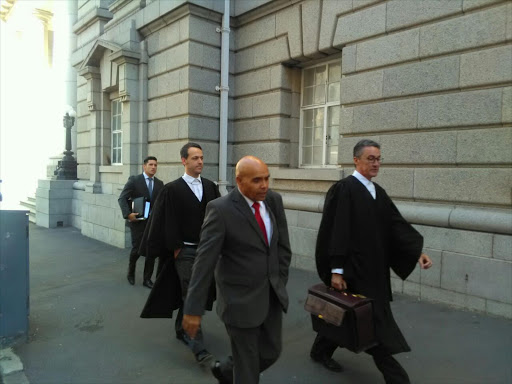 Andre Lincoln leaves the Cape Town High Court with his lawyers.
