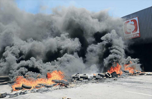 BURNING ANGER: More than 100 hawkers in Mdantsane took to the streets to demonstrate their anger over their removal from Sandile Street in front of Shoprite at the Highway in Mdantsane Picture: SINO MAJANGAZA