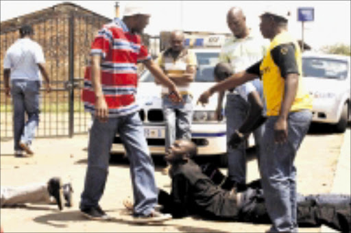 GOTCHA: Six robbers were arrested in Meadowlands, Soweto, after a shootout with cops. Pic.MOHAU MOFOKENG. 08/11/2009. © Sowetan. 08 NOVEMBER 2009 MMO --Eight robbers were arrested in Meadowlands, Soweto, after a shoot-out with cops. PHOTO MOHAU MOFOKENG