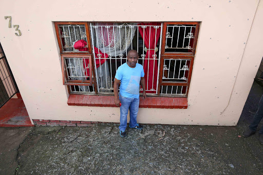 TARGETED: Ludumo Salman, CPF chairman for Duncan Village, stands in front of the blown-out windows of his house. A bomb was thrown at his house in Duncan Village on Sunday night Picture: STEPHANIE LLOYD