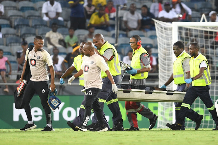 Makhehlene Makhaula of Orlando Pirates is stretchered off the pitch during the Nedbank Cup last-16 match against Hungry Lions at Orlando Stadium on Saturday.