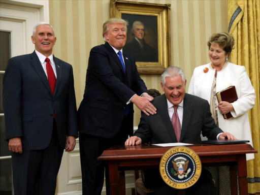 US President Donald Trump reacts during the swearing in ceremony for new US Secretary of State Rex Tillerson (2nd R) accompanied by his wife Renda St. Clair (R) and Vice President Mike Pence at the Oval Office of the White House in Washington, DC, US, February 1, 2017. /REUTERS
