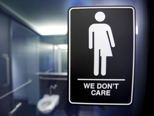A sign protesting a recent North Carolina law restricting transgender bathroom access adorns the bathroom stalls at the 21C Museum Hotel in Durham, North Carolina May 3, 2016./REUTERS