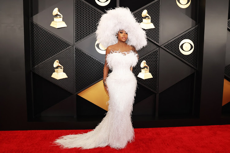 Summer Walker poses on the red carpet as she attends the 66th Annual Grammy Awards.