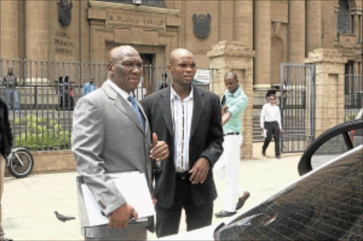 IRKED: Suspended national police commissioner General Bheki Cele, left, outside court yesterday. Cele is suing Sowetan for defamation of character after the paper produced a "manipulated" picture of him carrying a firearm in 2007. pHOTO: Mohau Mofokeng