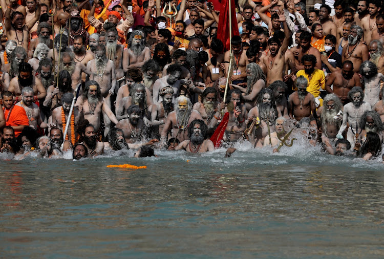 Naga Sadhus, or Hindu holy men take a holy dip in the Ganges River during Shahi Snan at "Kumbh Mela", or the Pitcher Festival, amidst the spread of the coronavirus disease (Covid-19), in Haridwar, India, April 14, 2021.