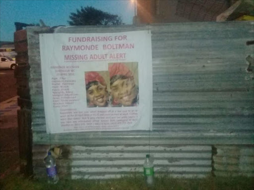 A missing person's poster of Raymode Boltman plastered on a wall during an outside service on Wednesday. She would have turned 26 years old. Picture: Genevieve Boltman