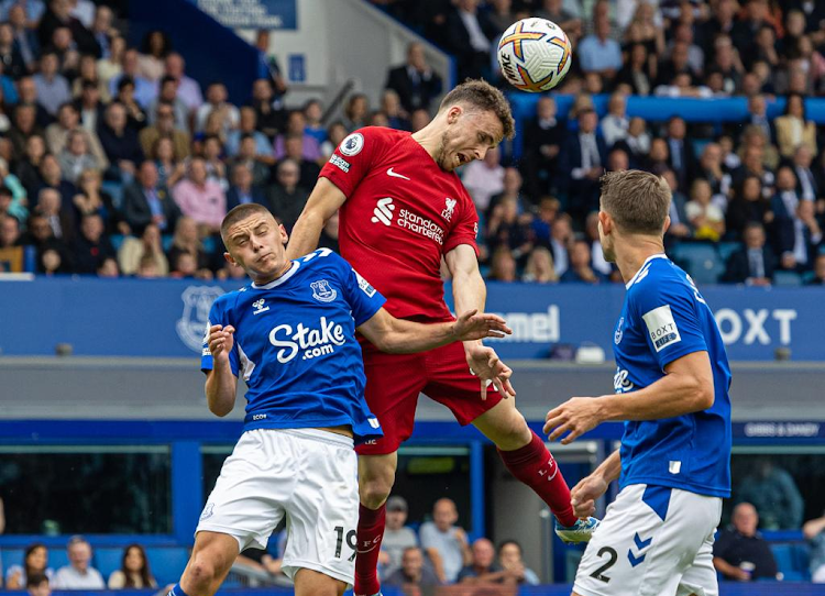 Liverpool's Diogo Jota (top) vies for a header with Everton's Vitalii Mykolenko (L) during the English Premier League match between Everton and Liverpool on Sept. 3, 2022.