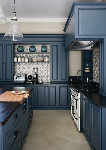 This deep-blue hue adds sophistication to this kitchen and matches perfectly with the concrete floor and patterned tiles.