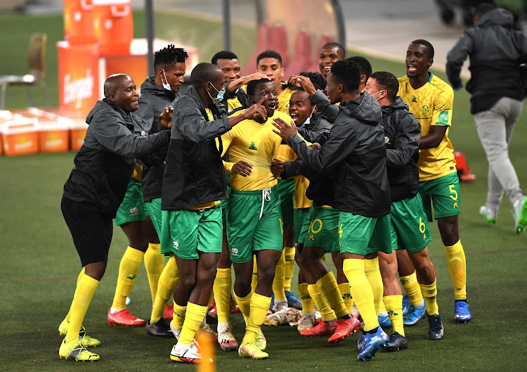Bongokuhle Hlongwane is surrounded by his teammates after scoring Bafana Bafana's winning goal in their 2022 Fifa World Cup qualifier against Ghana at FNB Stadium on September 6, 2021.