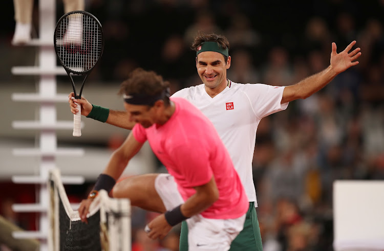 Switzerland's Roger Federer with Spain's Rafael Nadal after winning their exhibition match at Cape Town Stadium in Cape Town on February 7 2020.