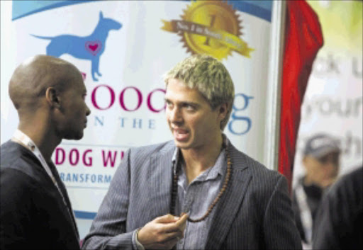'Dog whisperer' James Lech, right, at his stall at a dog and cat show at Gallagher Estate in Sandton yesterday