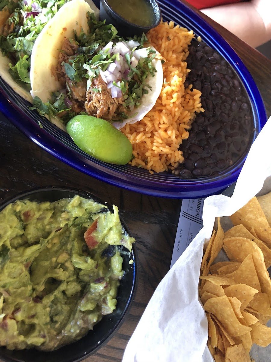 Guacamole and chips. Those are the mexican street tacos on the blue plate!