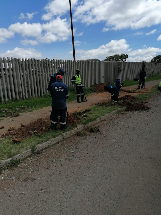 City of Ekurhuleni employees fixing a cable fault in Kempton Park. The workers face daily threats from unruly thugs waiting to pounce.