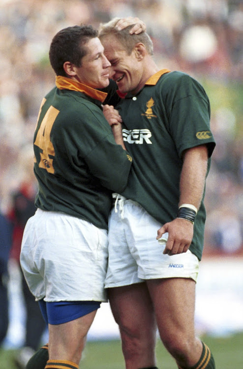 A file photo of former South African rugby captain Franscois Pienaar (R) congratulating James Small (L) on his tries against the British Lions at Ellis Park in Johannesburg. South Africa.