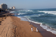People seen walking on the beach at Umhlanga, in February 2012.
