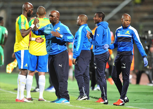 Mamelodi Sundowns coach Pitso Mosimane and his players in a discussion during the match.