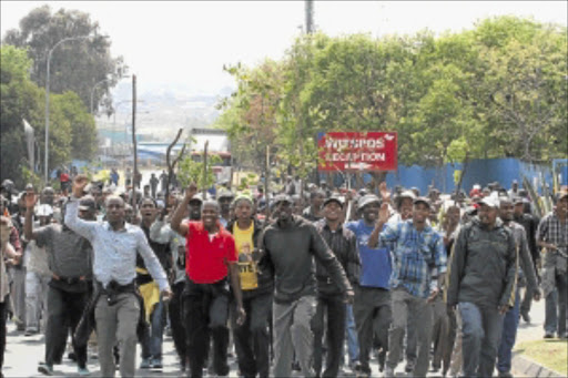 MOB RAGE: Temporary South African Post Office workers went on strike at the Witspos mail centre in Ormonde, Johannesburg, yesterday. The protesters are demanding that they be employed permanently. The mail centre is the biggest in South Africa and processes about 15 million items a day. PHOTO: BAFANA MAHLANGU