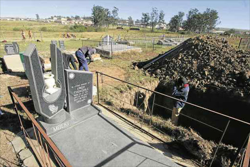 FINAL PREPARATIONS: Workers finished making a grave for MaMbeki at the cemetery in Dutywa yesterday morning. The struggle icon will be buried on Saturday next to her daughter Linda, who died in 2003 Picture: LULAMILE FENI