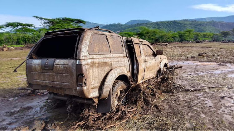 A car stuck in mud and debris after a river broke banks and wrecked havoc in Kamuchiri Village in Mai Mahiu, Nakuru County on April 29, 2024.