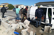 City of Cape Town officials fix a leaking water main outside the torched Khayelitsha house on September 4 2019.