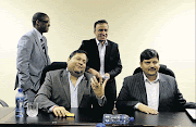 POWERFUL: Ajay and Atul Gupta, seated, and, standing,  Duduzane Zuma and Jagdish Parekh have proved to be influential enough to write to the president to make  the
government, intervene on their behalf while they have the Banking Ombudsman to sort out their problems, says the writer. Photo: Muntu Vilakazi/Gallo Images