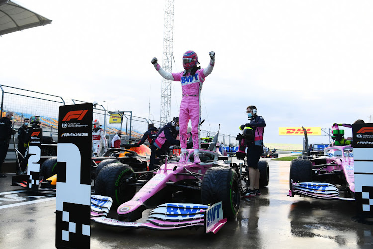 Pole position qualifier Lance Stroll of Canada and Racing Point celebrates in parc ferme during qualifying ahead of the F1 Grand Prix of Turkey at Intercity Istanbul Park on November 14, 2020 in Istanbul, Turkey.