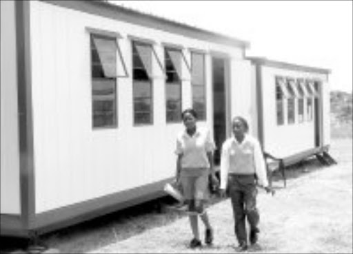 TEMPORARY SOLUTION: Two pupils at Dr AMS Makunyane High School in Seshego, near Polokwane, walk to thier mobile classroom. Pic. Edward Maahlamela. 15/01/2007. © Sowetan.