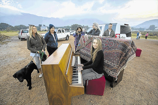 HITTING THE RIGHT NOTE: Ann Middleton tinkles the ivories at the Noordhoek sports fields at sunrise yesterday