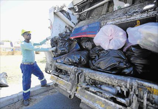 WORKING GRADUATE: Avuyile Bene, 29, a Walter Sisulu University public relations graduate, in his sixth year doing the only work he could get – collecting and loading trash for Buffalo City Metro’s solid waste department